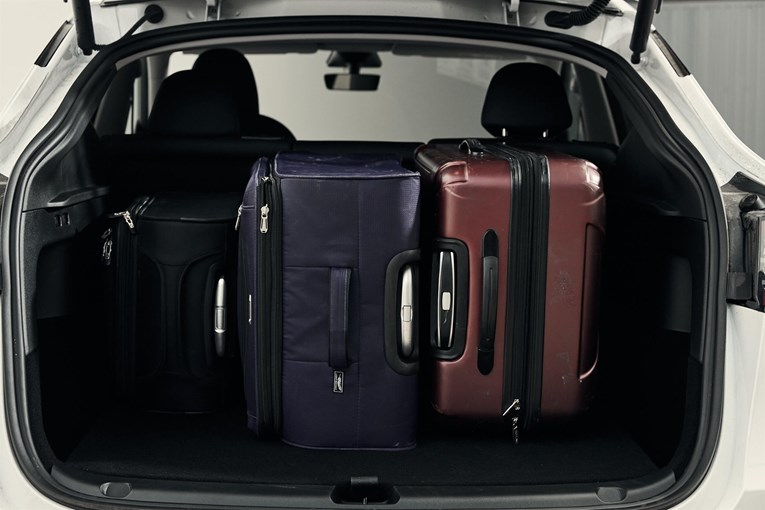 Tesla Model Y open trunk with luggage.