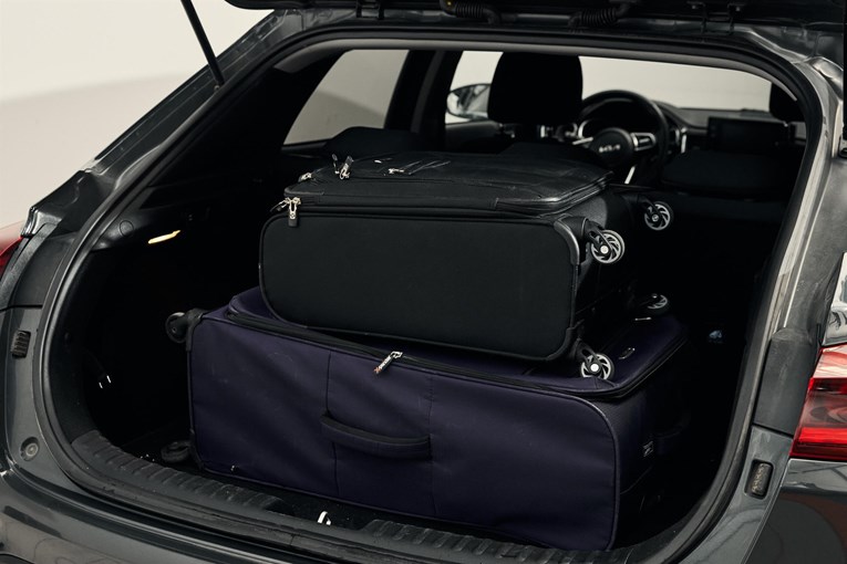 Kia rental car open trunk with luggage. 