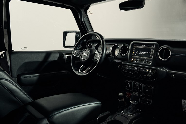 Jeep Wrangler Rubicon interior featuring steering wheel and  intuitive touchscreen infotainment system.