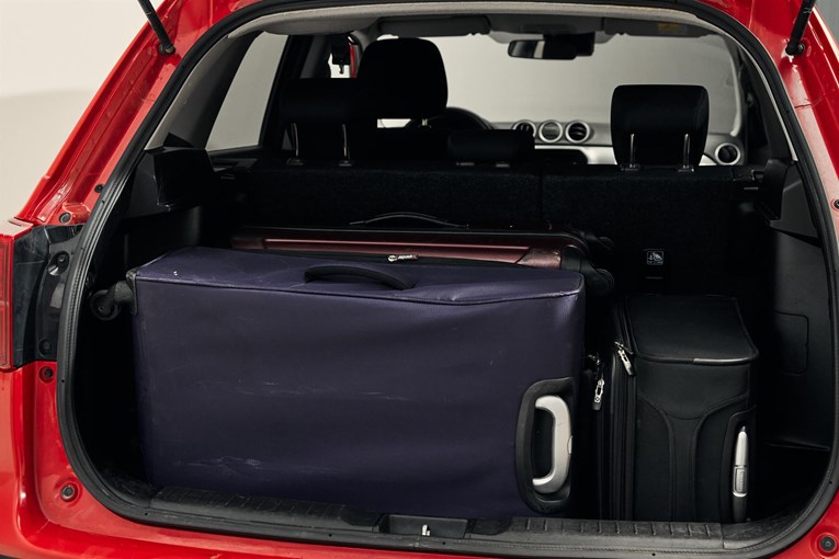Suzuki Vitara open trunk with luggage. 