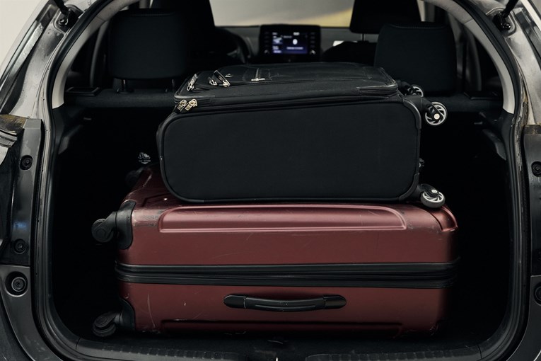 Toyota Yaris open trunk with luggage. 