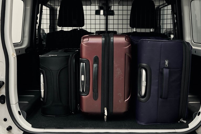 Suzuki Jimny open trunk with luggage. 