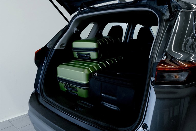 Nissan X-Trail open trunk with luggage.